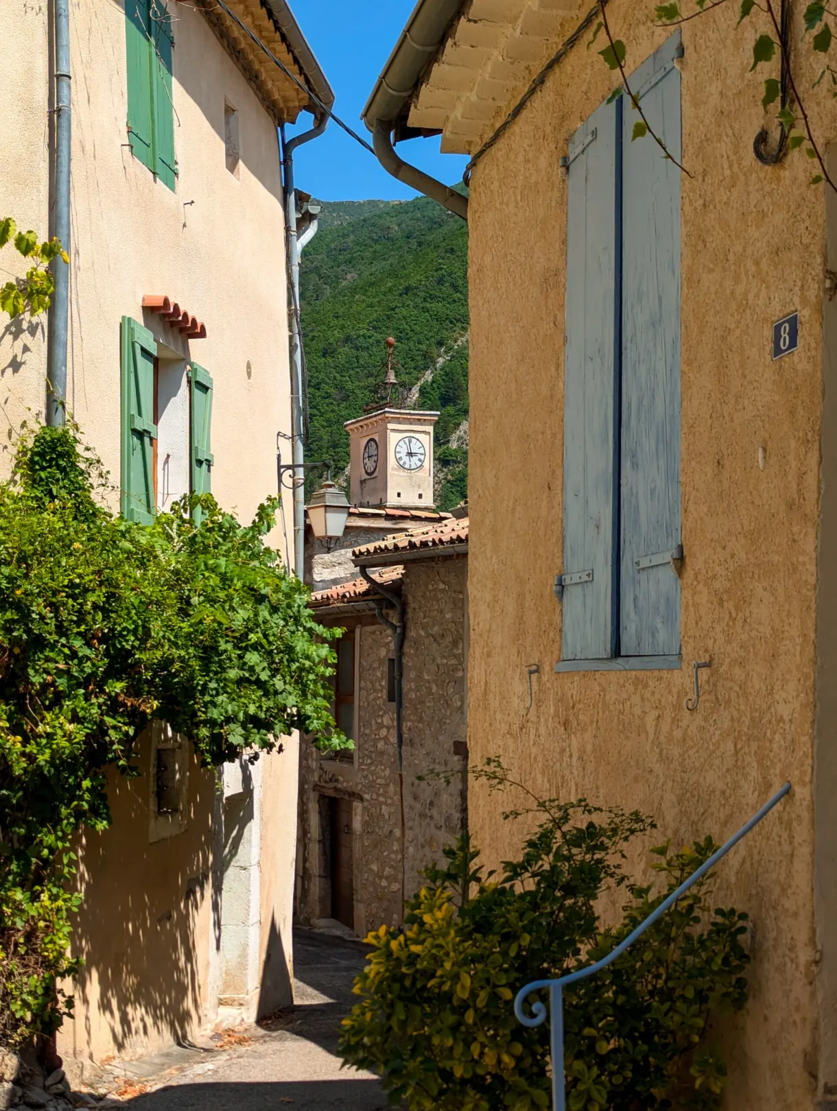 Narrow lane opening onto the village clock tower