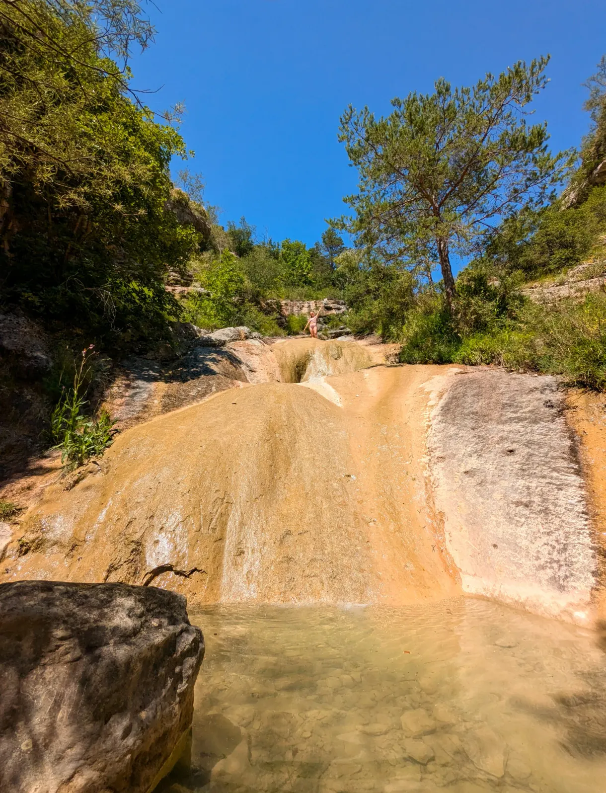 Slide of ochre rock polished by the running water