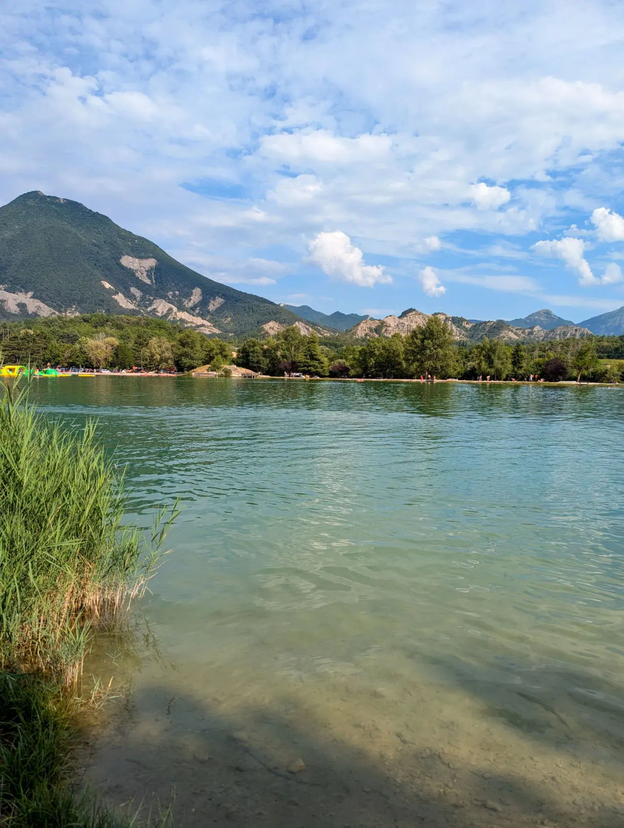 Stretch of water lined with reeds with the mountain in the background