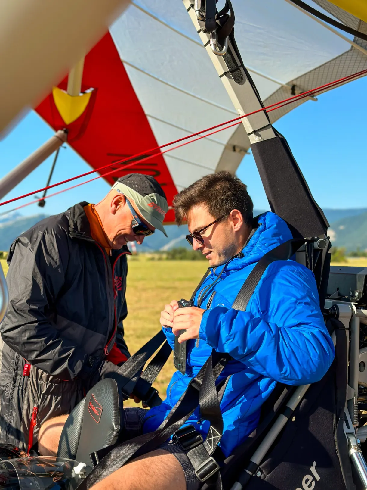 Pilot strapping in his passenger before the microlight flight