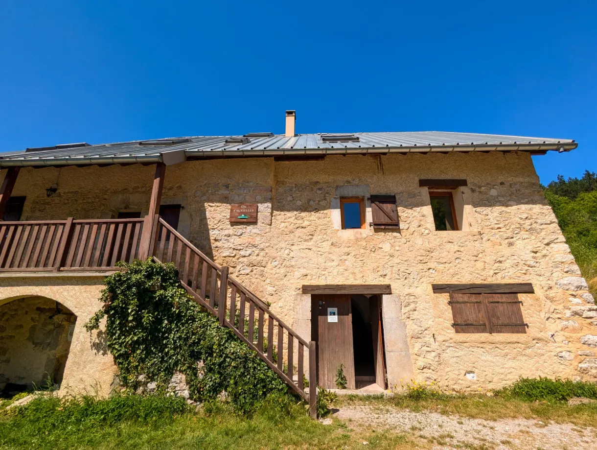 Stone building with an outside staircase and a wooden balcony