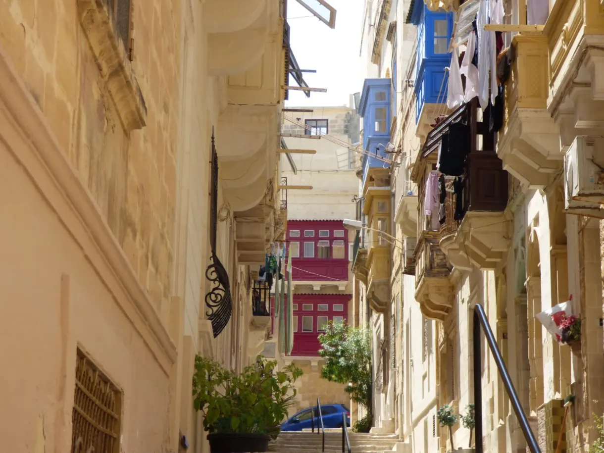 Lane with colourful wooden balconies and washing hung out