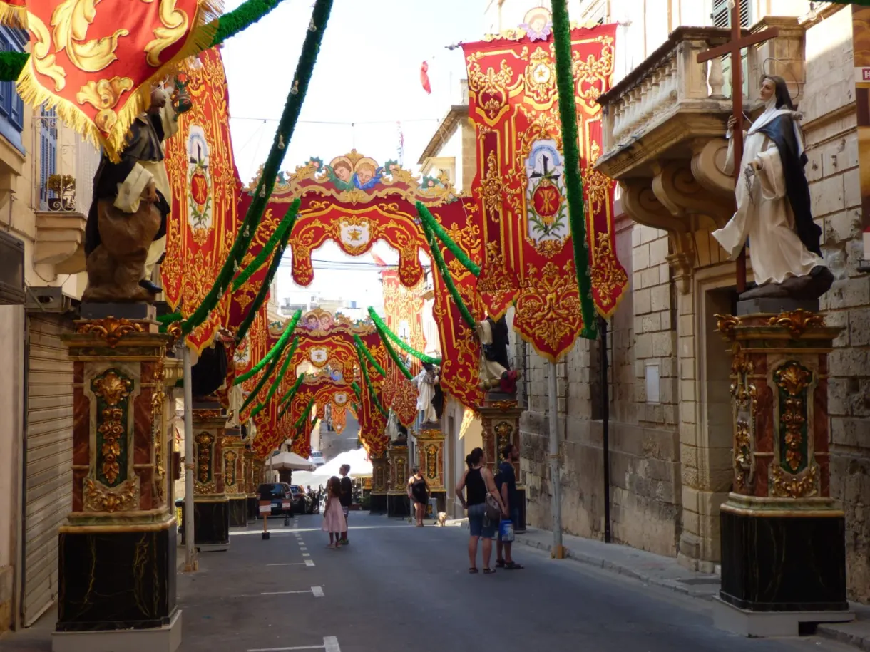 Street hung with red and gold drapes for the feast