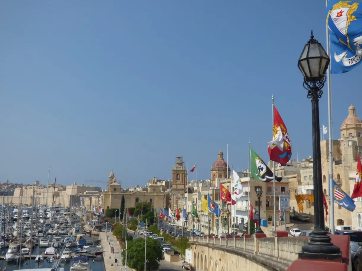 Harbour and bell towers seen from a bunting-hung viewpoint