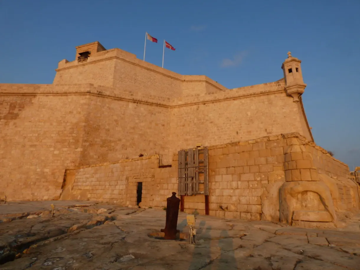 Golden stone bastion and flags in the setting sun