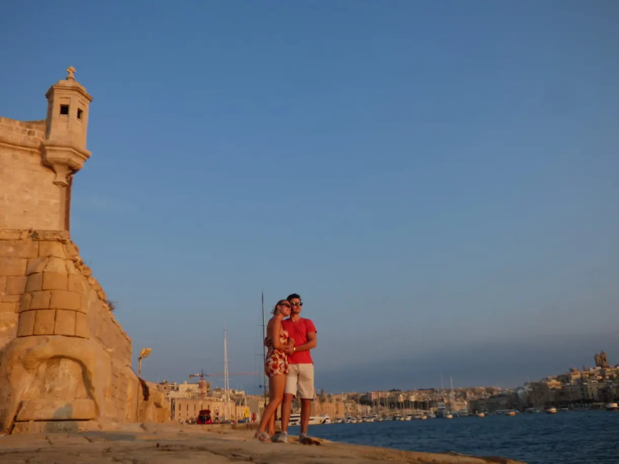 Couple posing in front of the stone watchtower of the bastion