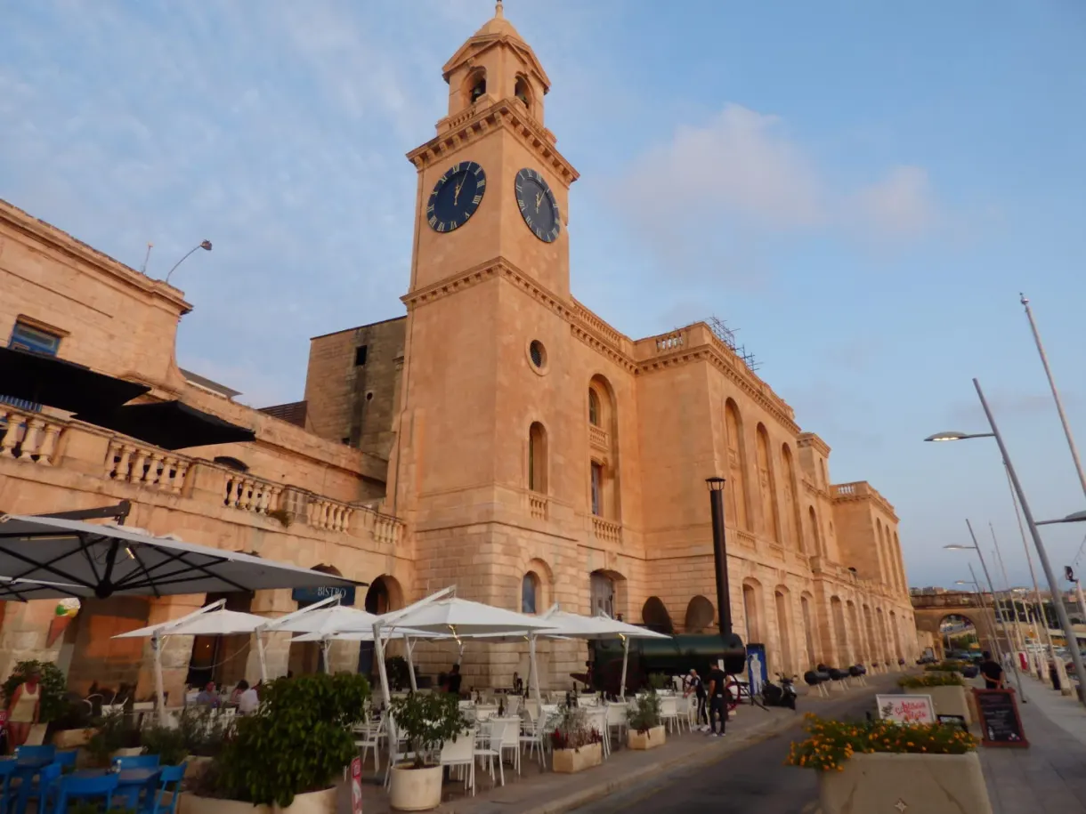 Clock tower and restaurant terraces on the quay