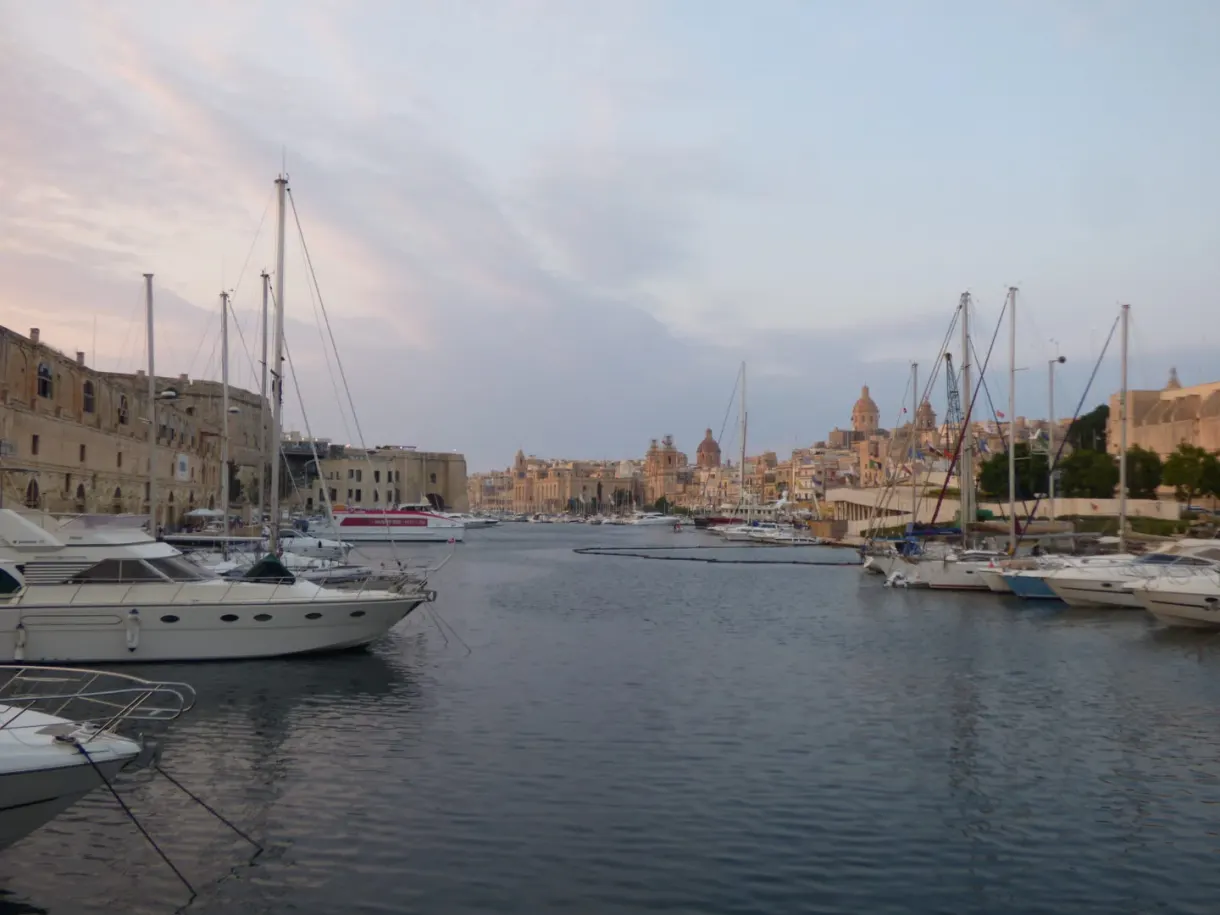 Yachts and bell towers of the marina at dusk
