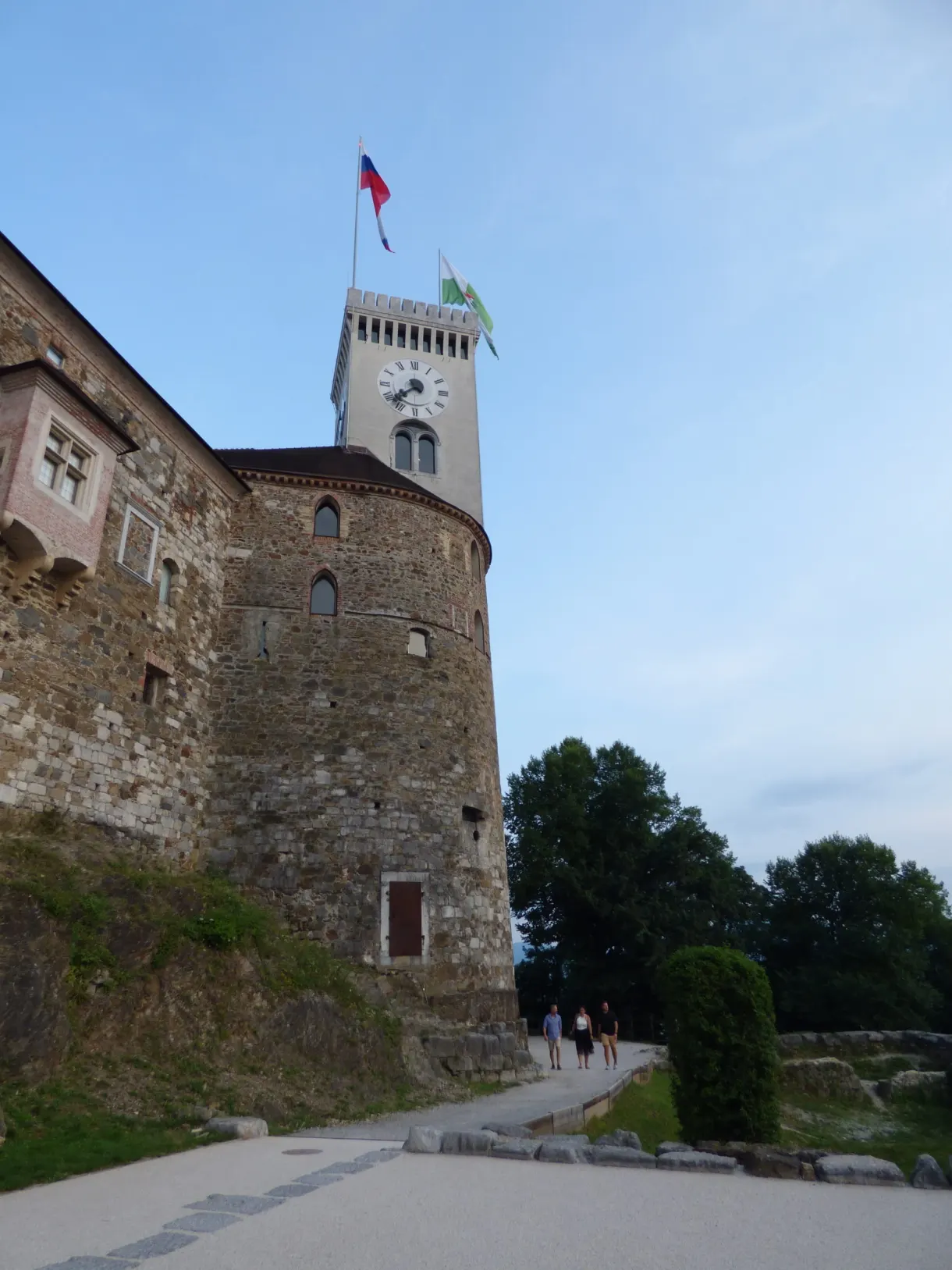 Gravel path climbing towards the clock tower of the castle
