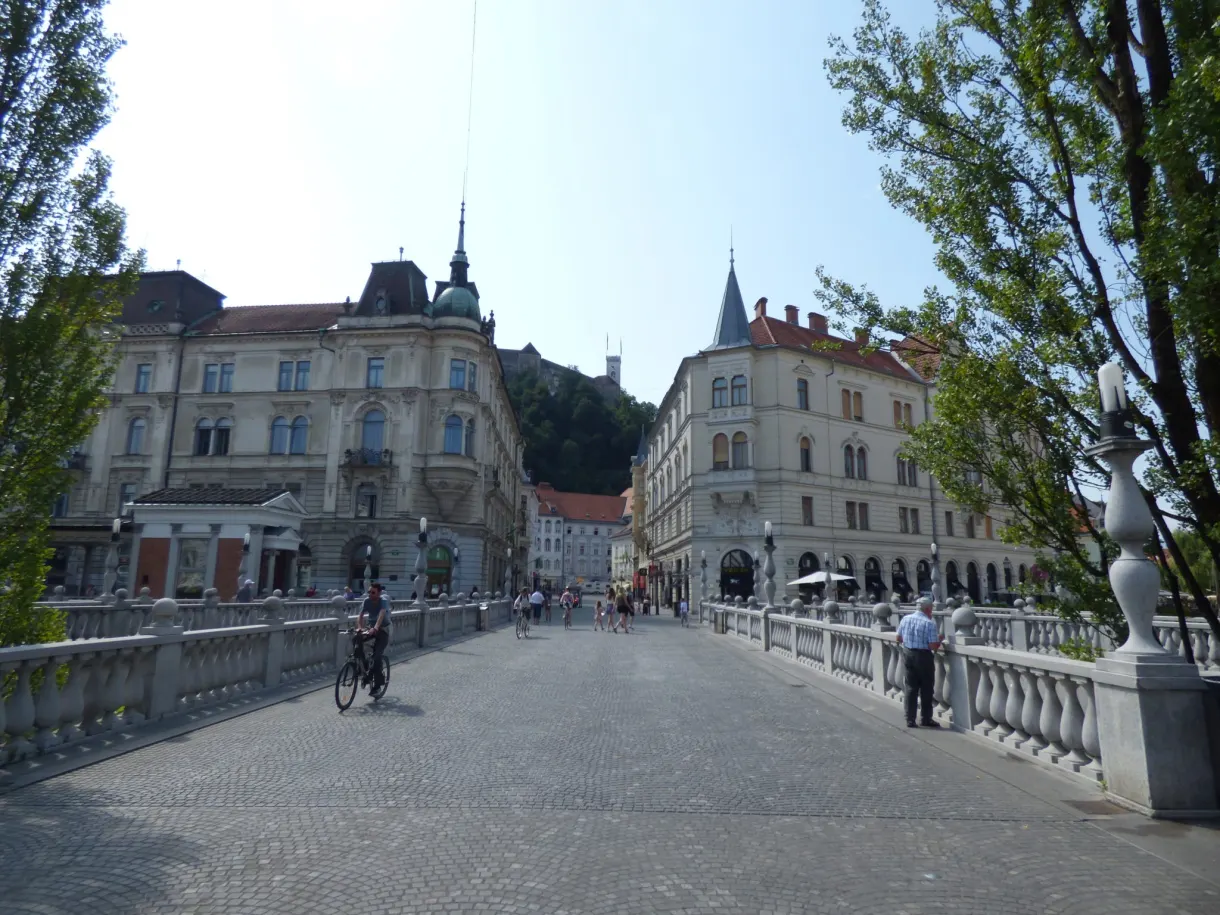 White balustrades of the triple bridge crossed by passers by