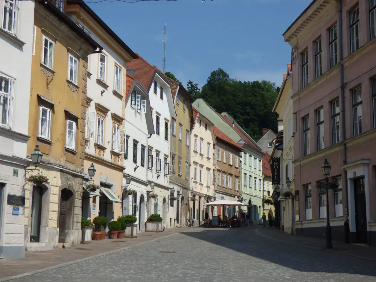 Cobbled street lined with ochre facades and old lanterns