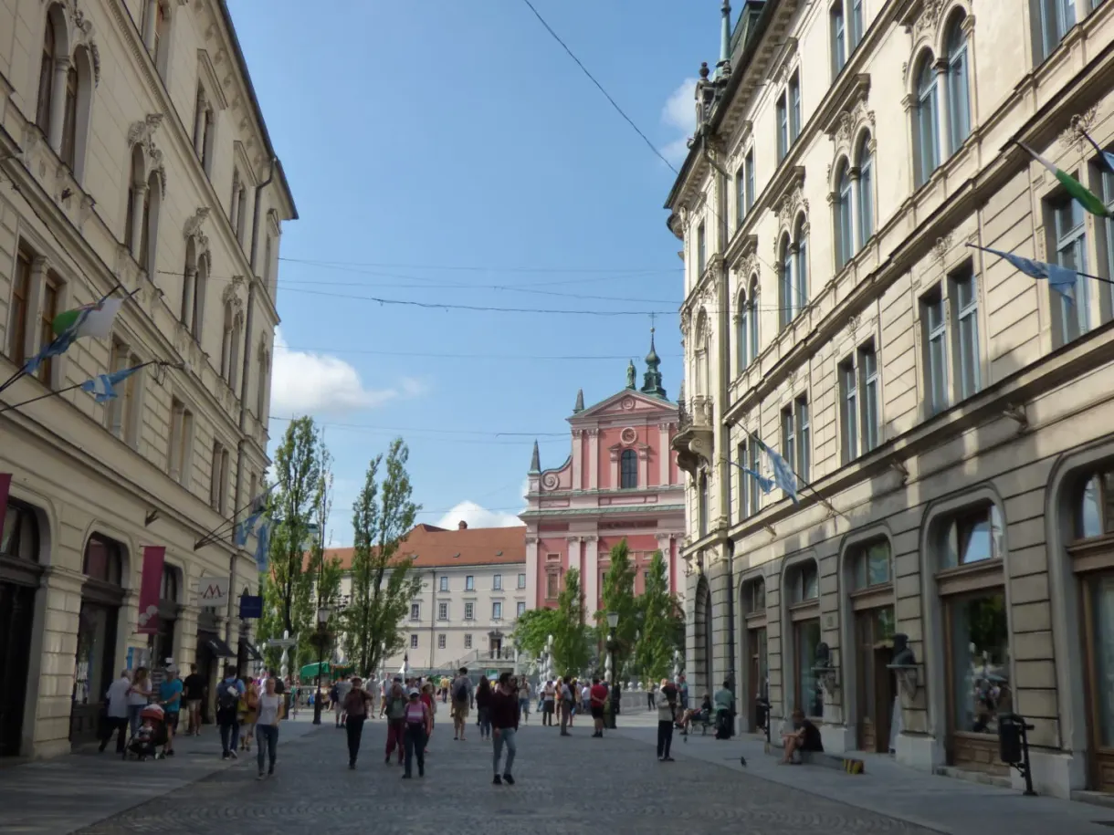 Busy pedestrian avenue leading to the pink church
