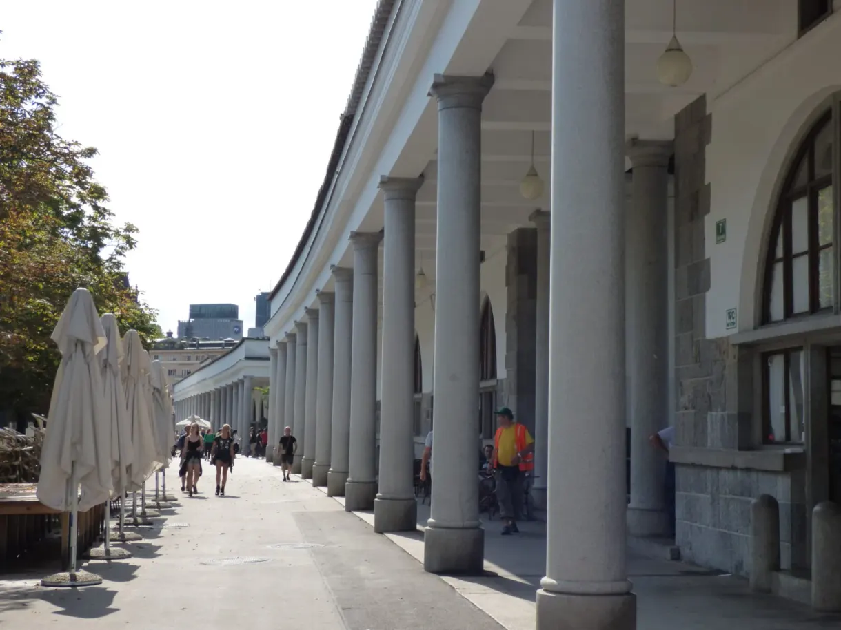 White colonnade of the covered market, parasols folded away