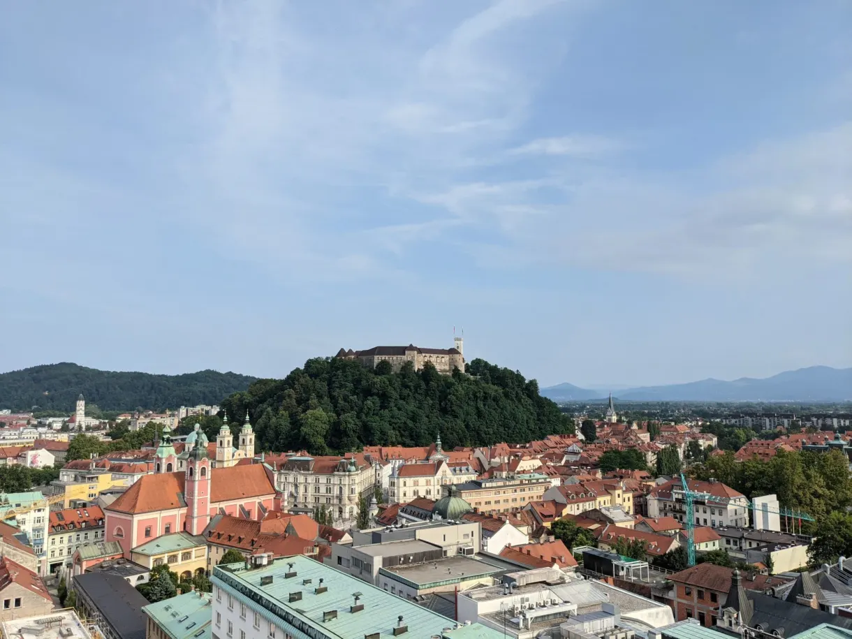 Castle overlooking the red rooftops seen from a high balcony
