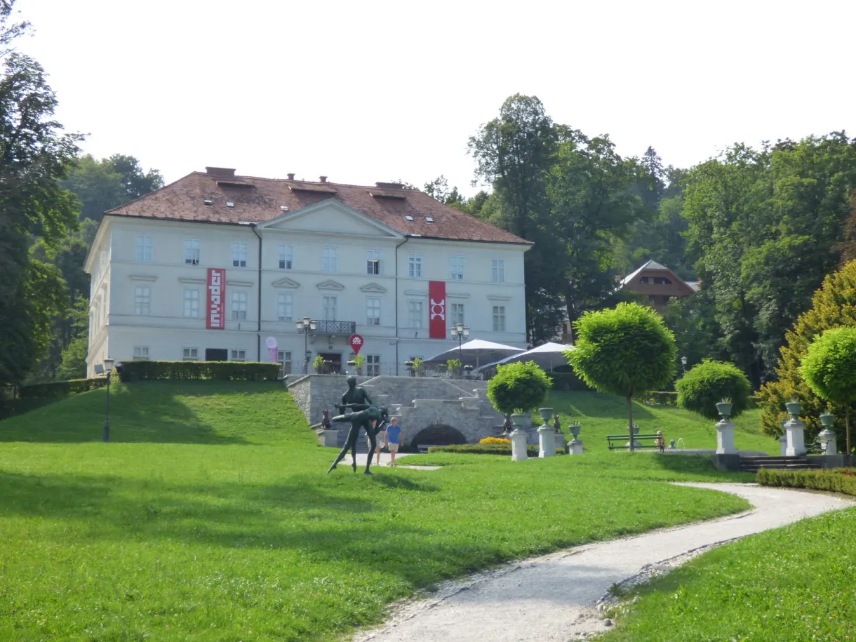 White manor house of the park at the end of a large lawn
