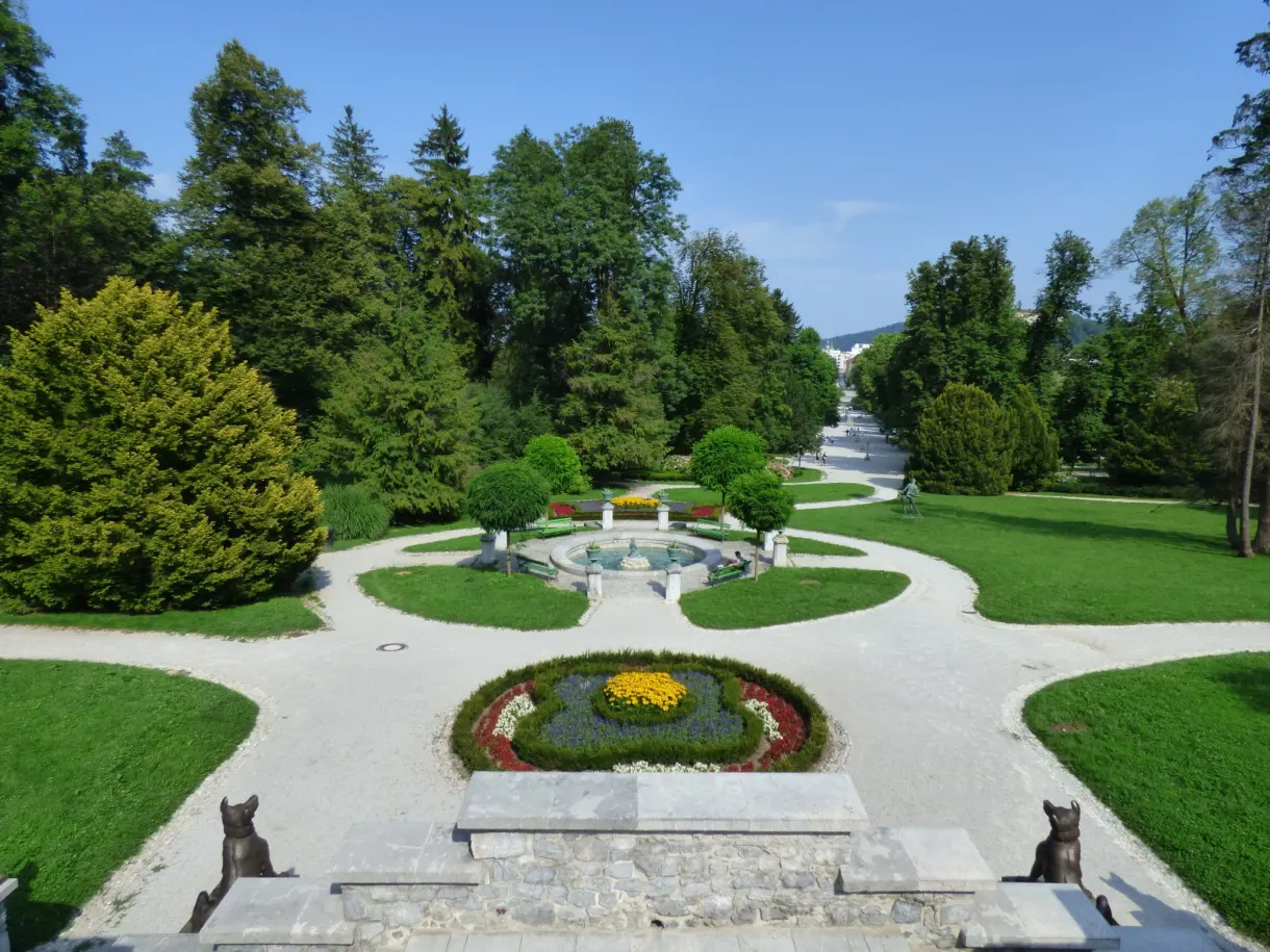 Circular flower bed and gravel paths guarded by two stone dogs