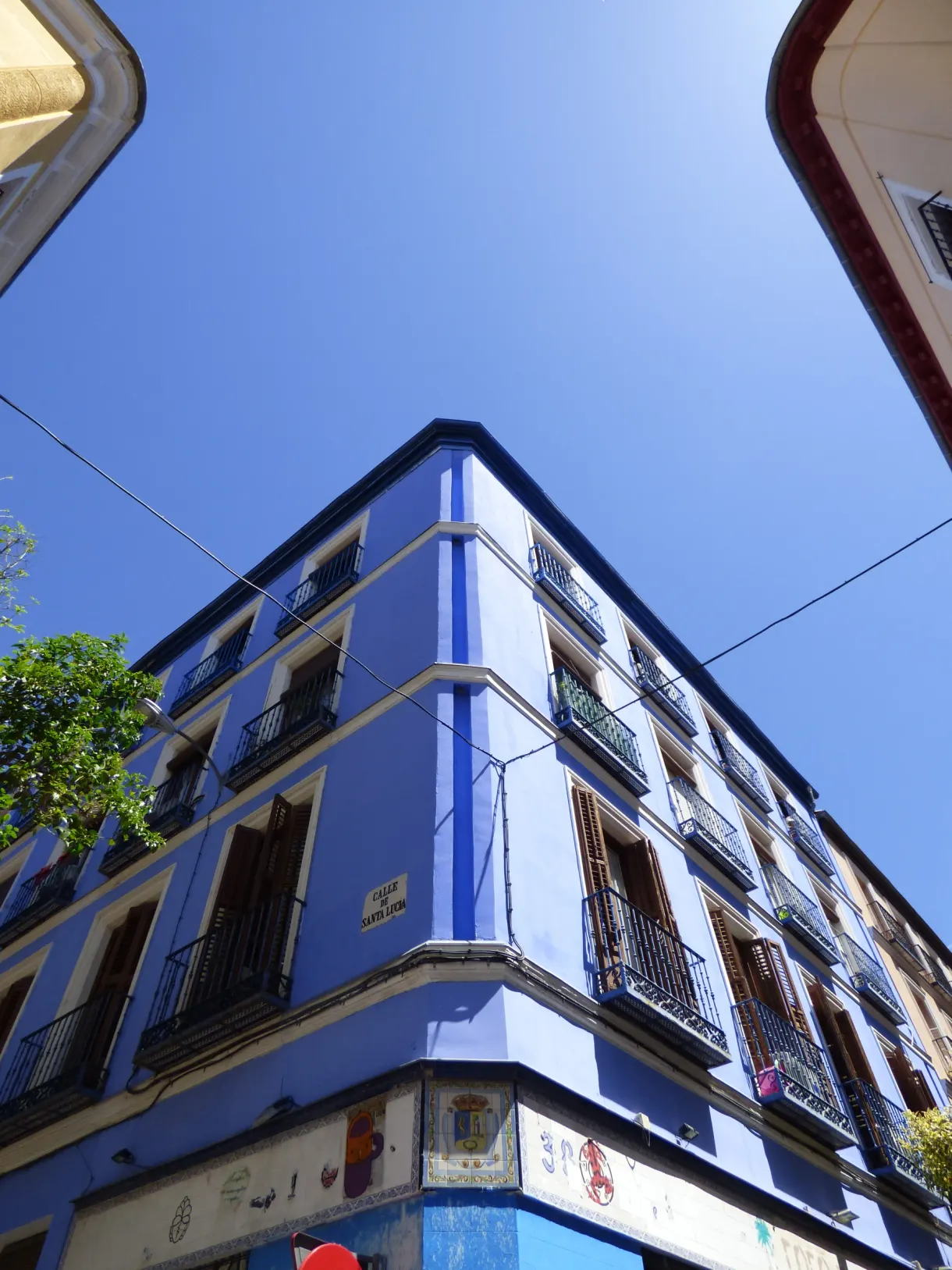 Corner building painted bright blue seen from below
