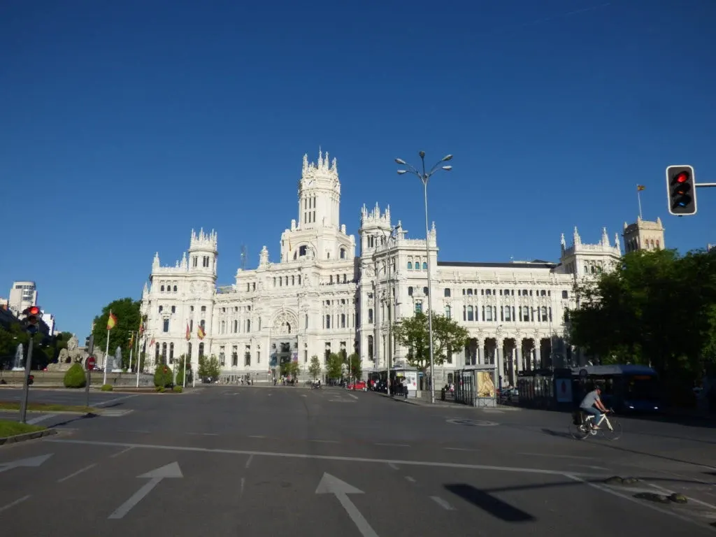 White Cibeles palace at the end of a deserted avenue