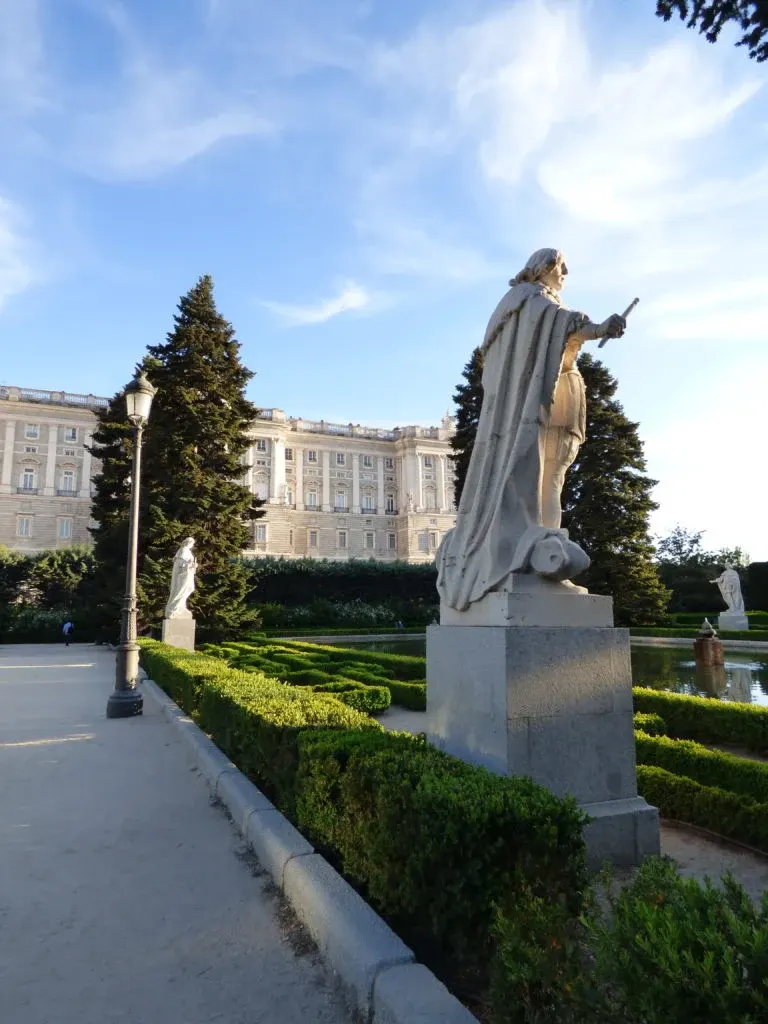 Stone statue of a monarch lined up in the palace gardens