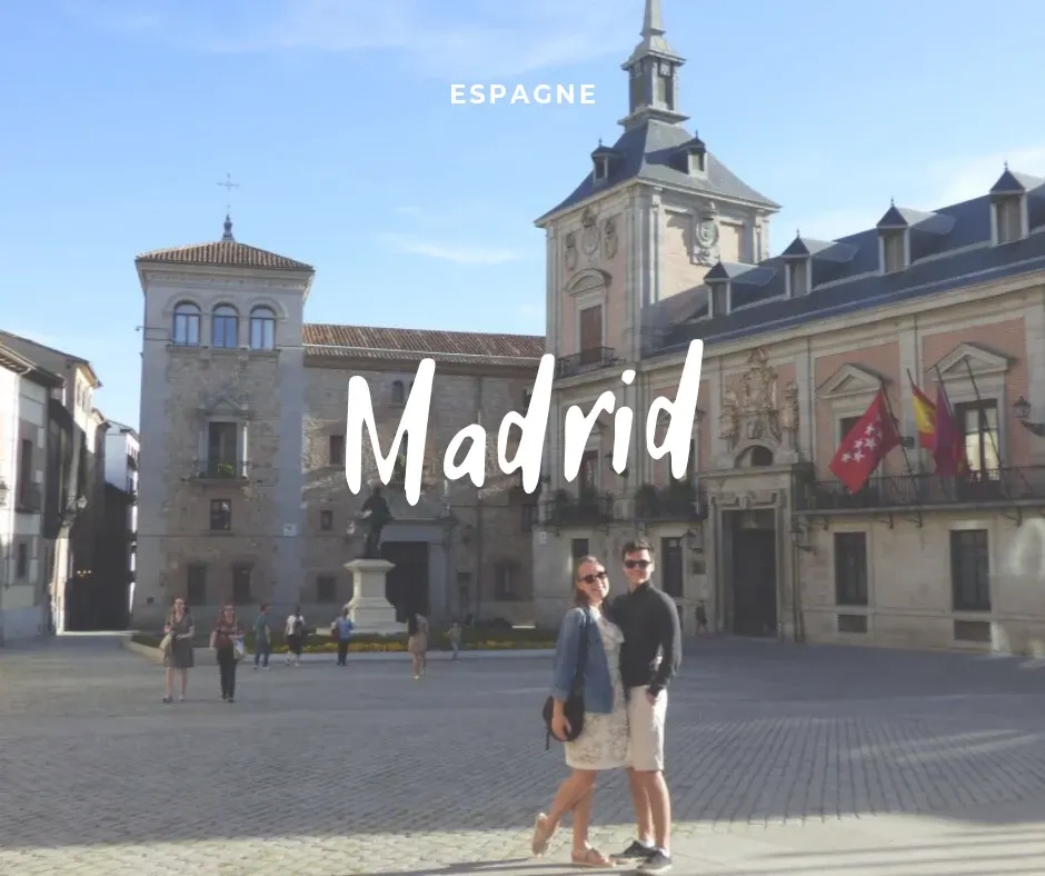 Couple on a square lined with buildings of brick and stone