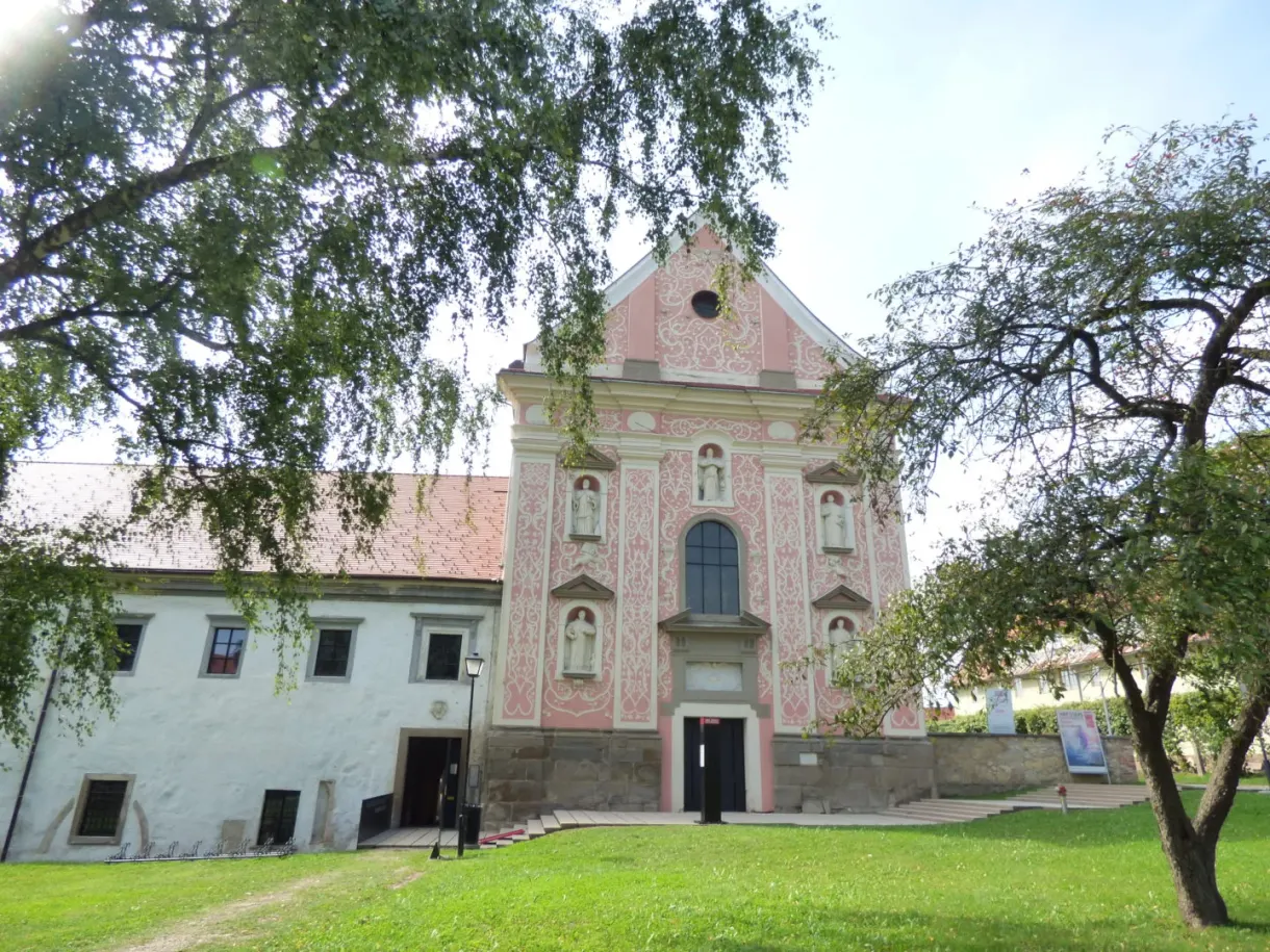 Pink facade of a baroque church and its monastery