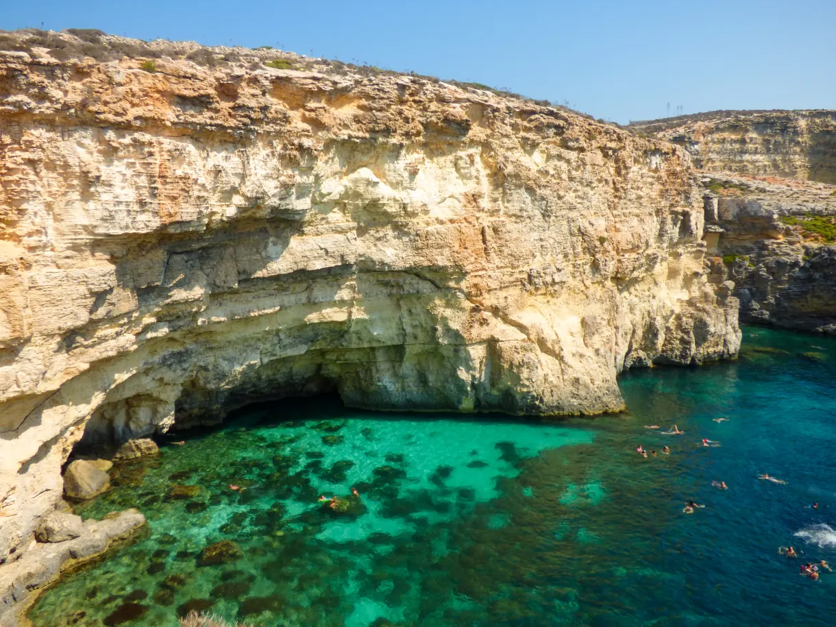 Turquoise water in front of the rocks of Comino
