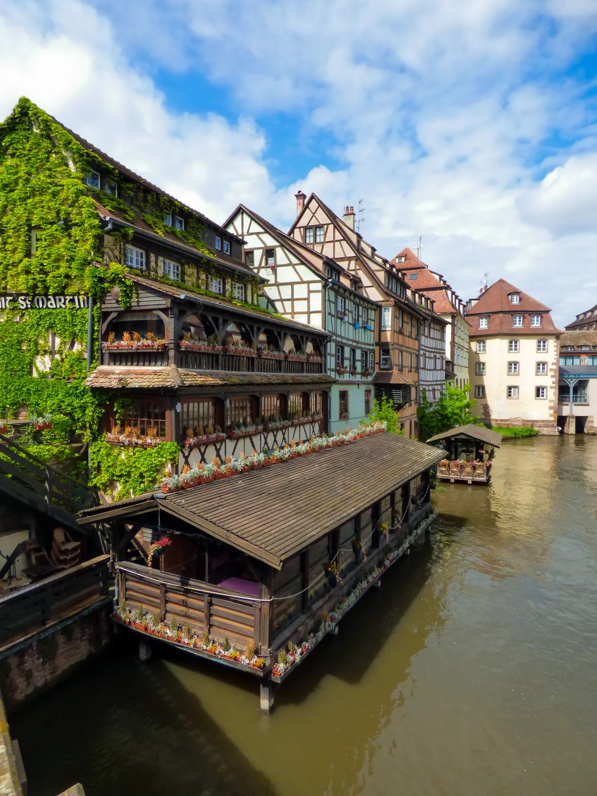 Old house covered in ivy at the water's edge, Alsace cover