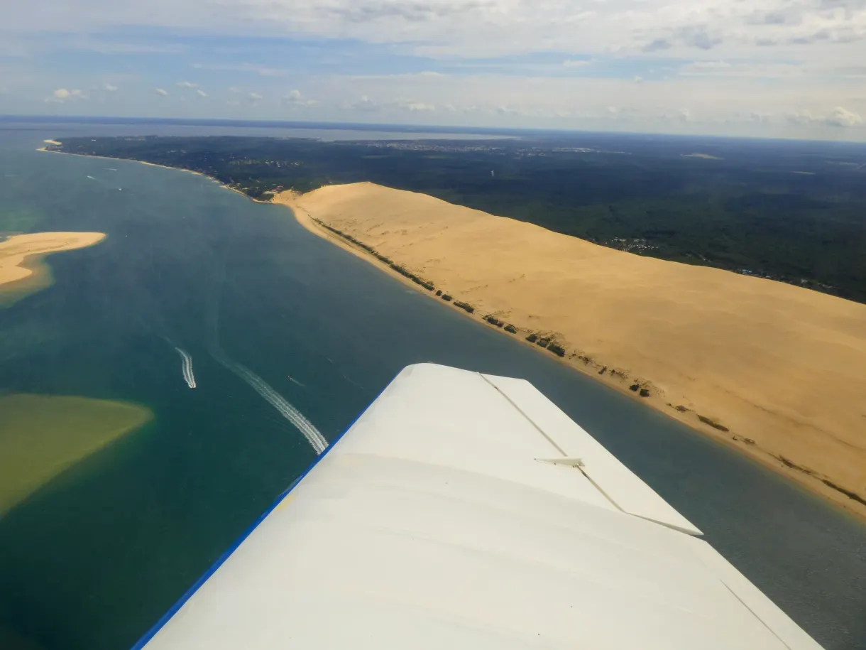 Red paraglider above the dune and the Arcachon basin