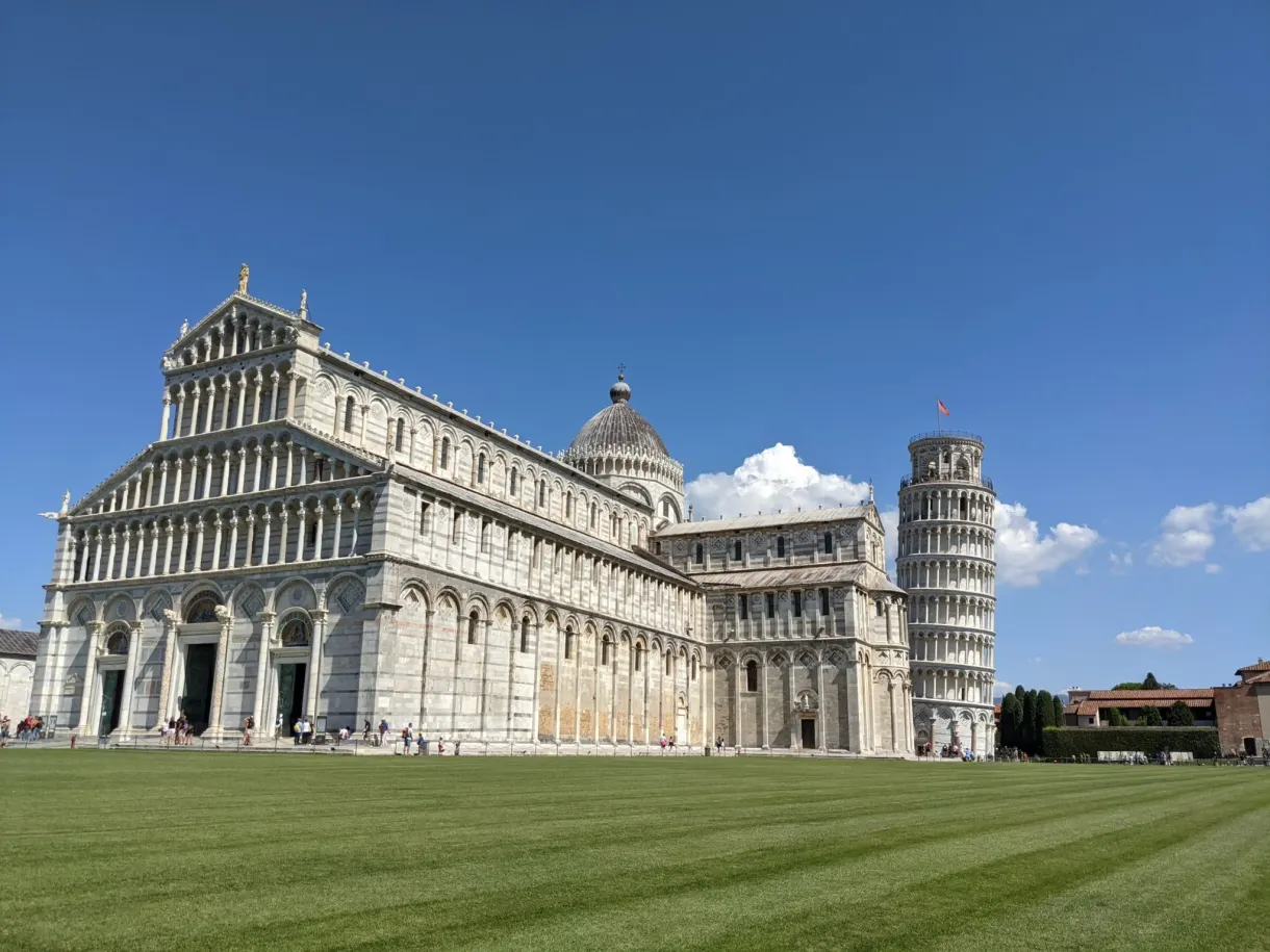 Cathedral and leaning tower lined up behind the mown lawn