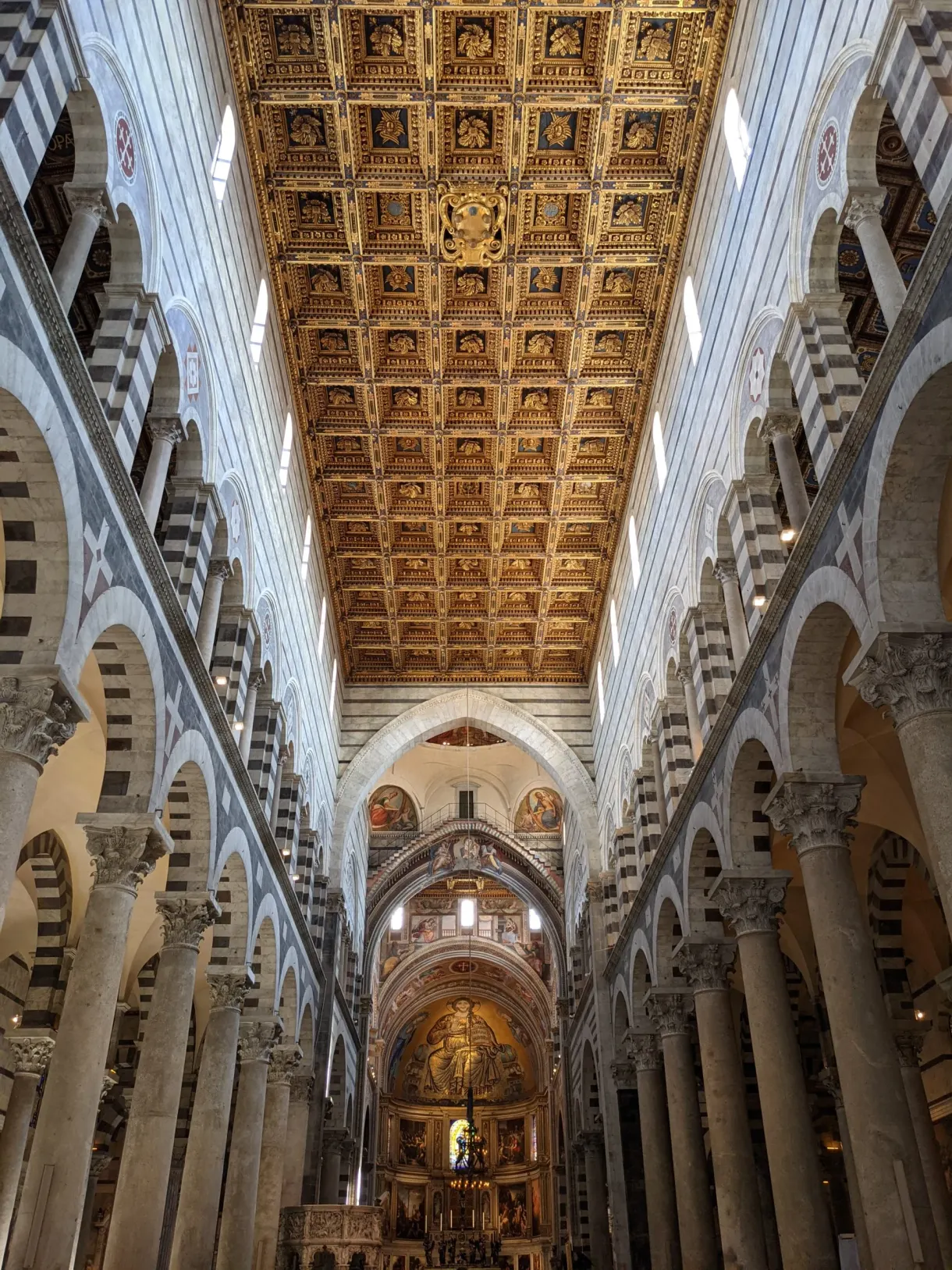 Gilded coffered ceiling above the striped nave