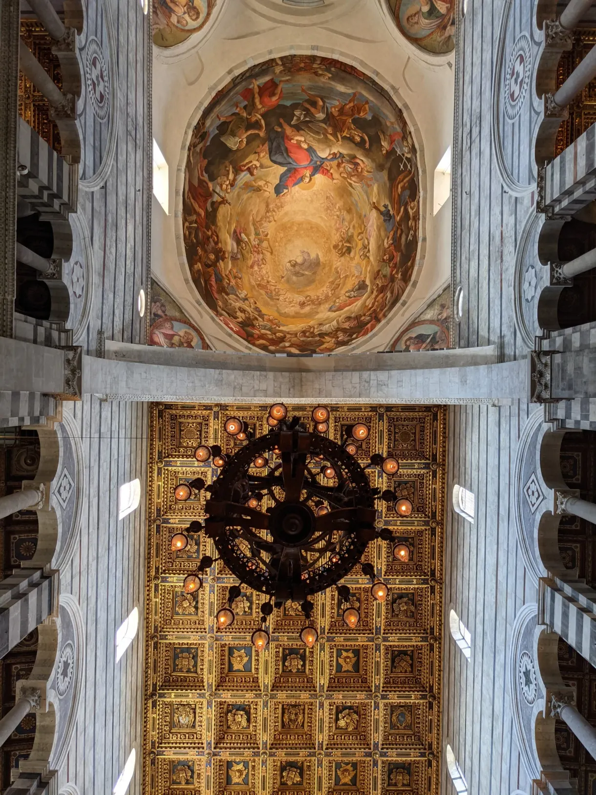 Painted dome and hanging chandelier seen from below