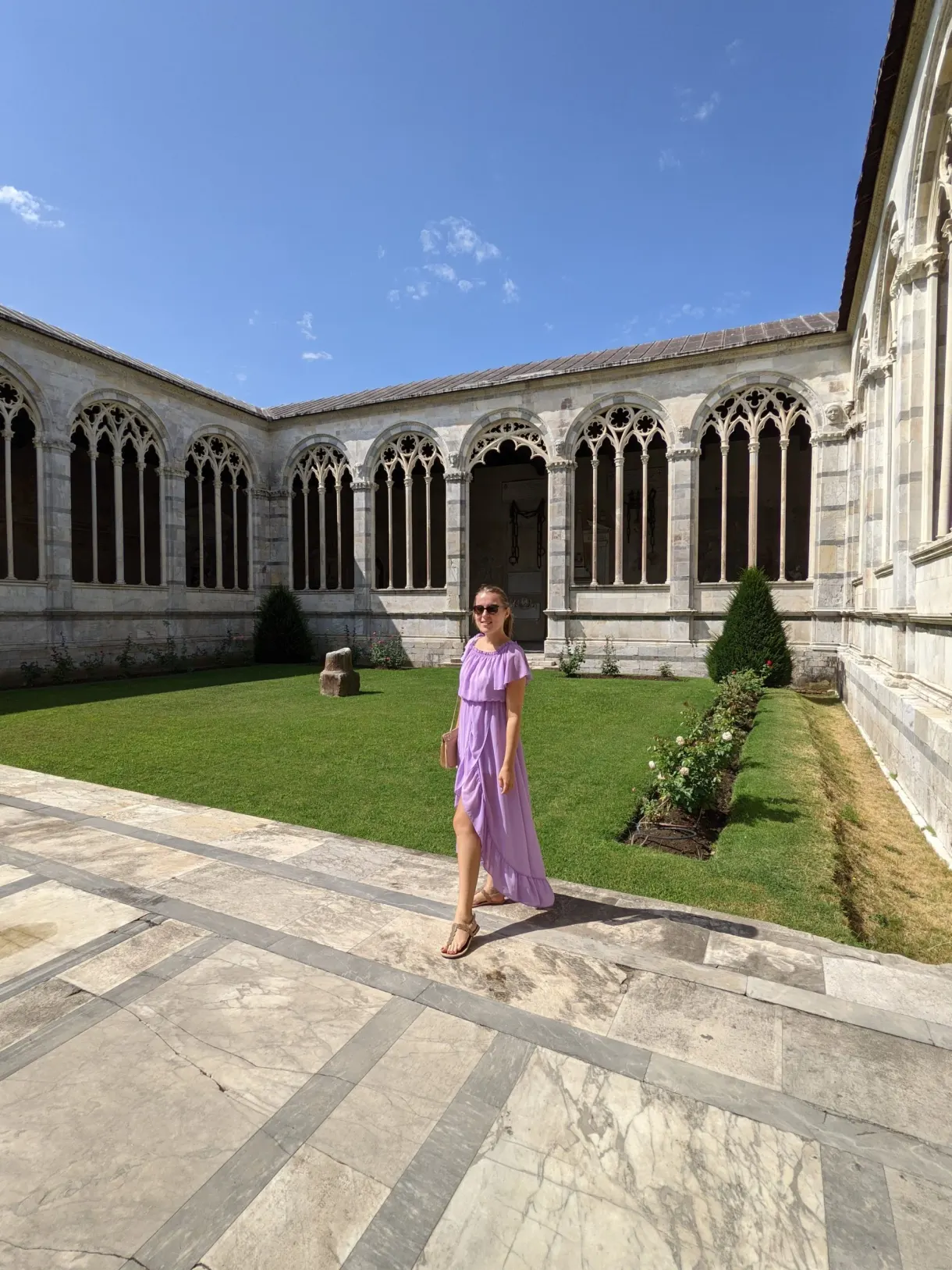 Woman in a purple dress in the inner courtyard of the Camposanto