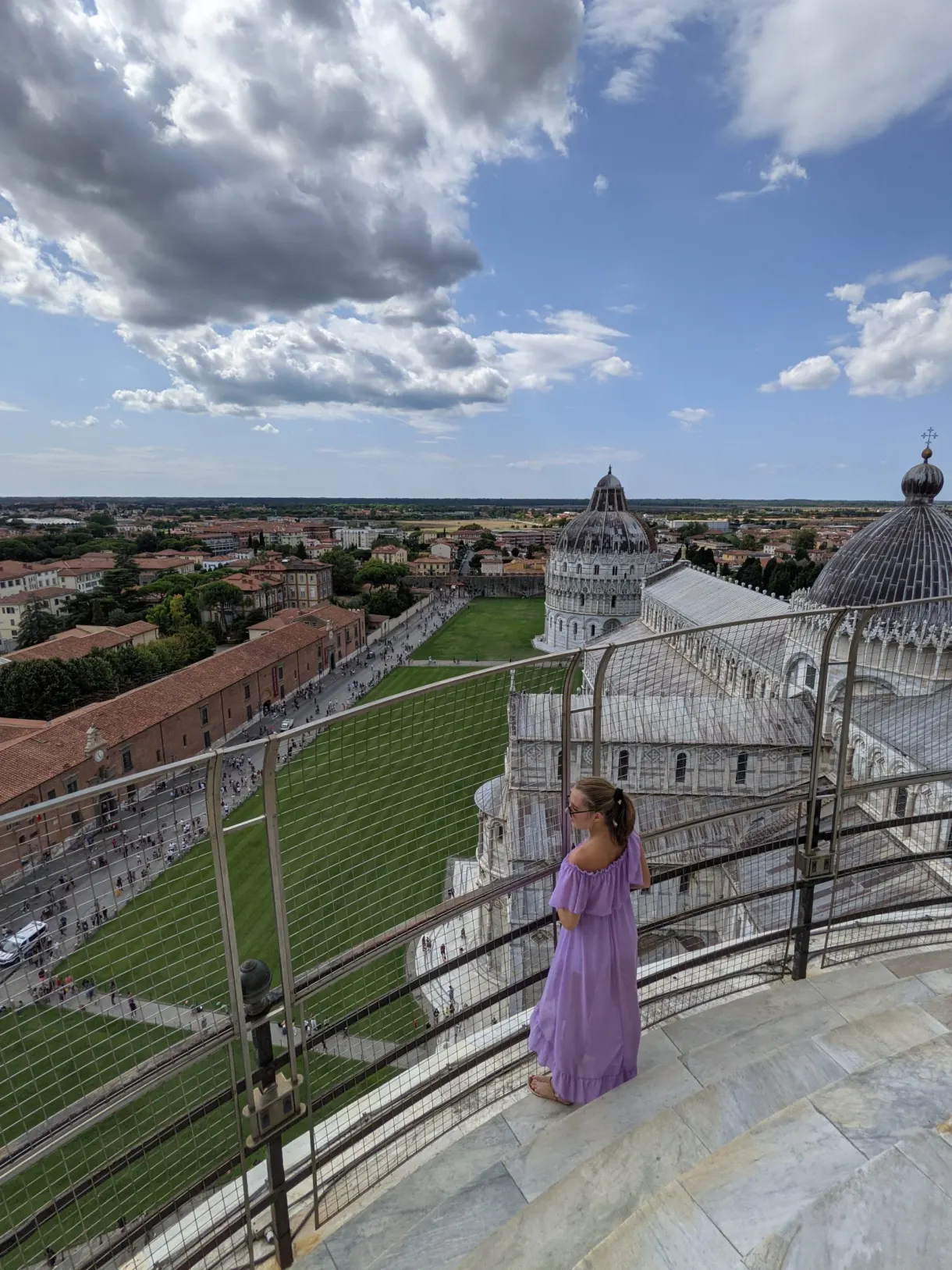 Woman in a purple dress at the top of the tower, the square below