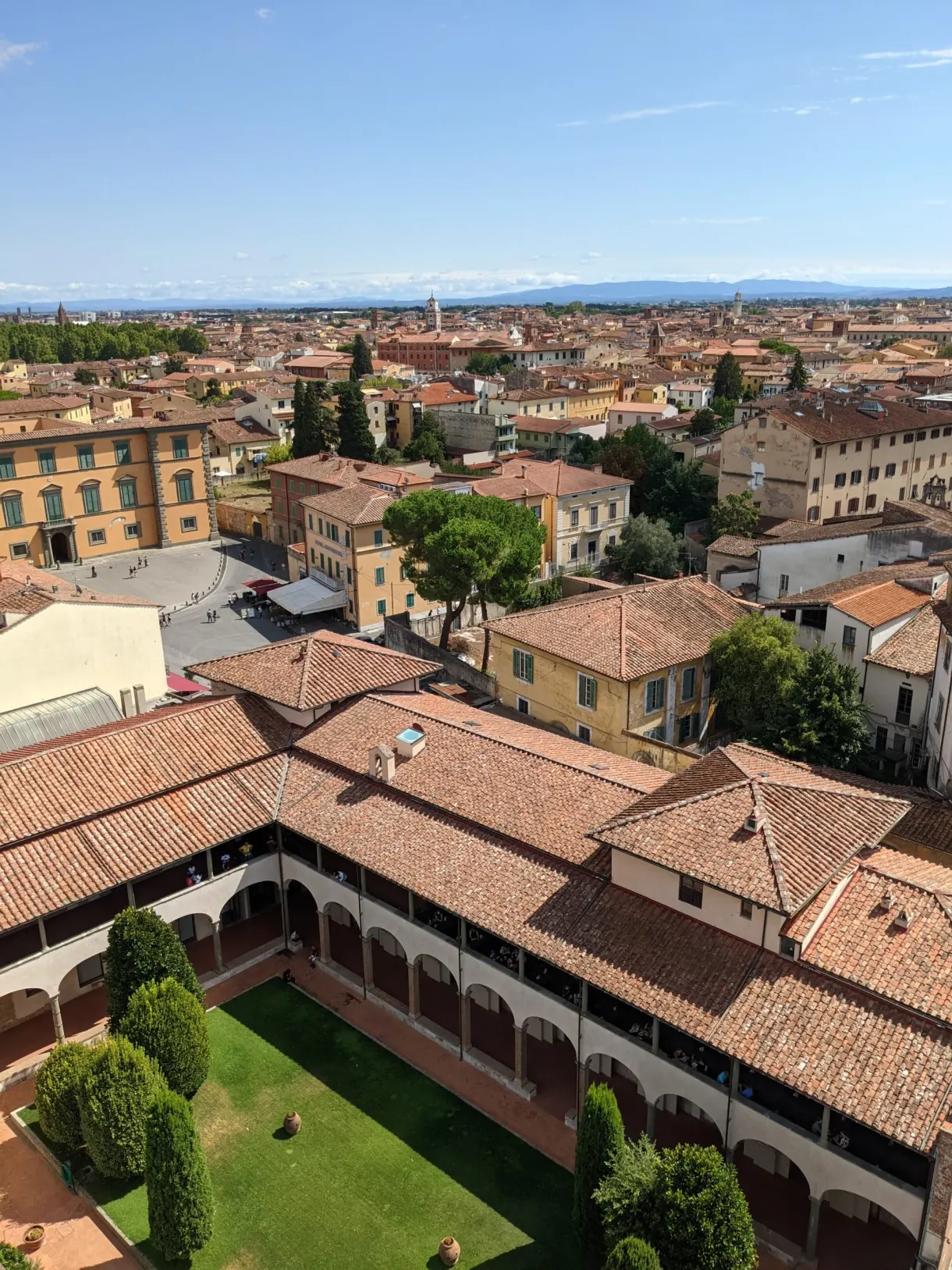 Cloister with tiled roofs glimpsed from the top of the tower