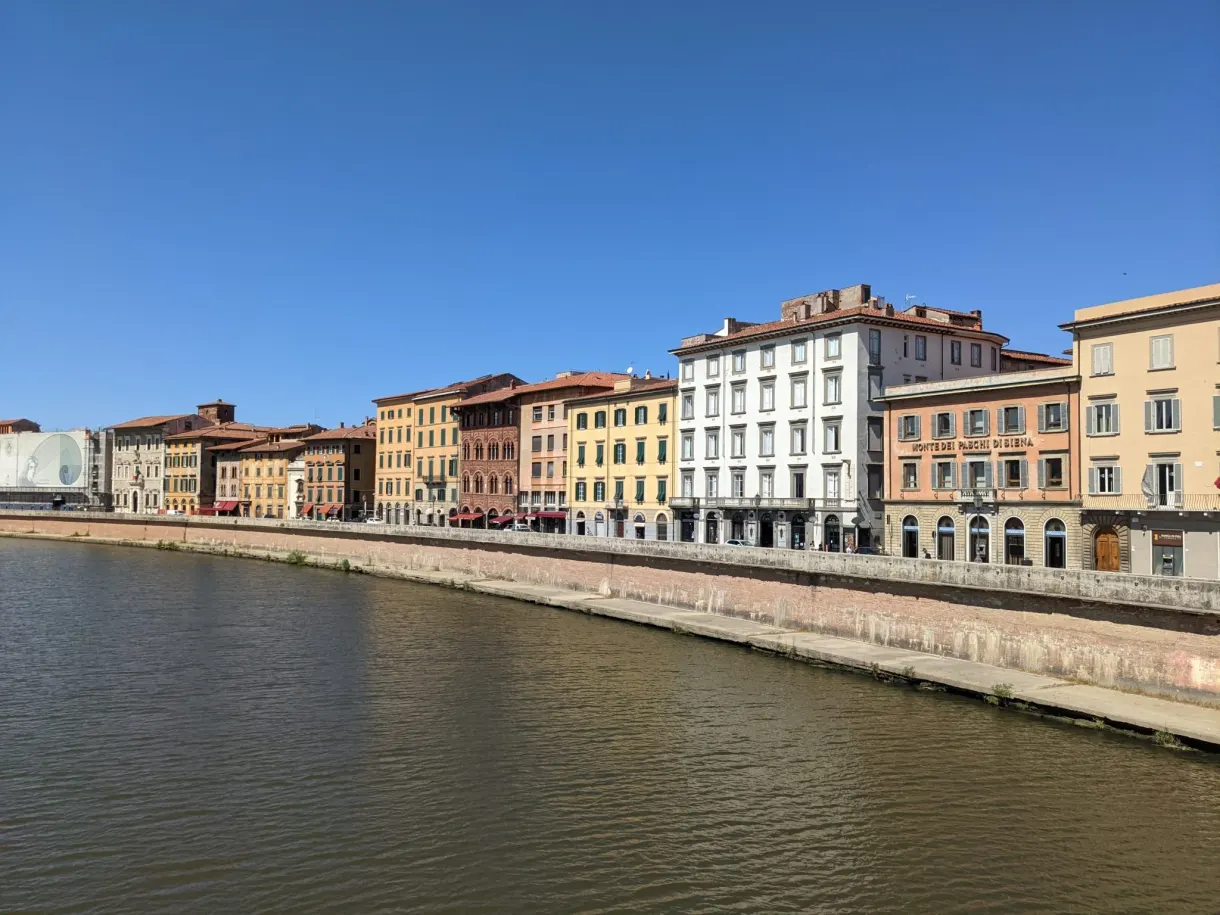 Buildings lined up along the quay beside the Arno