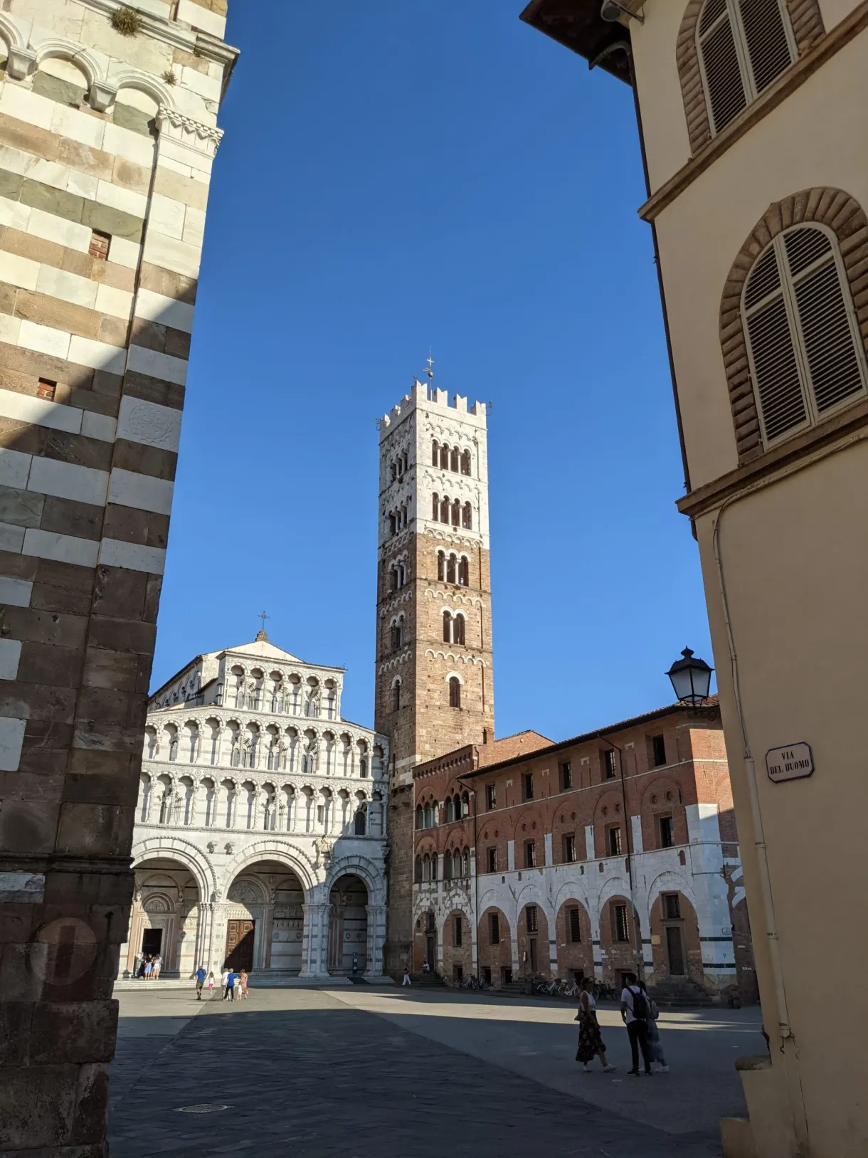 Bell tower of the cathedral framed by a narrow lane