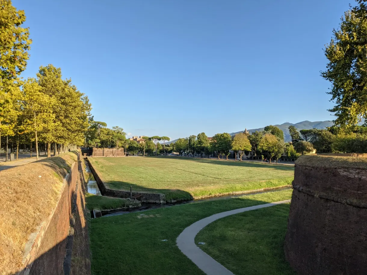 Path winding at the foot of the grassy ramparts of Lucca