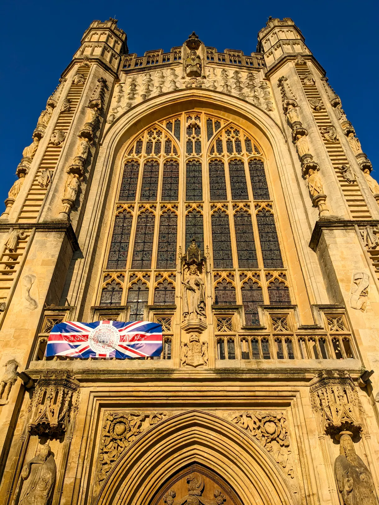 Bath Abbey in bright sunshine with blue sky