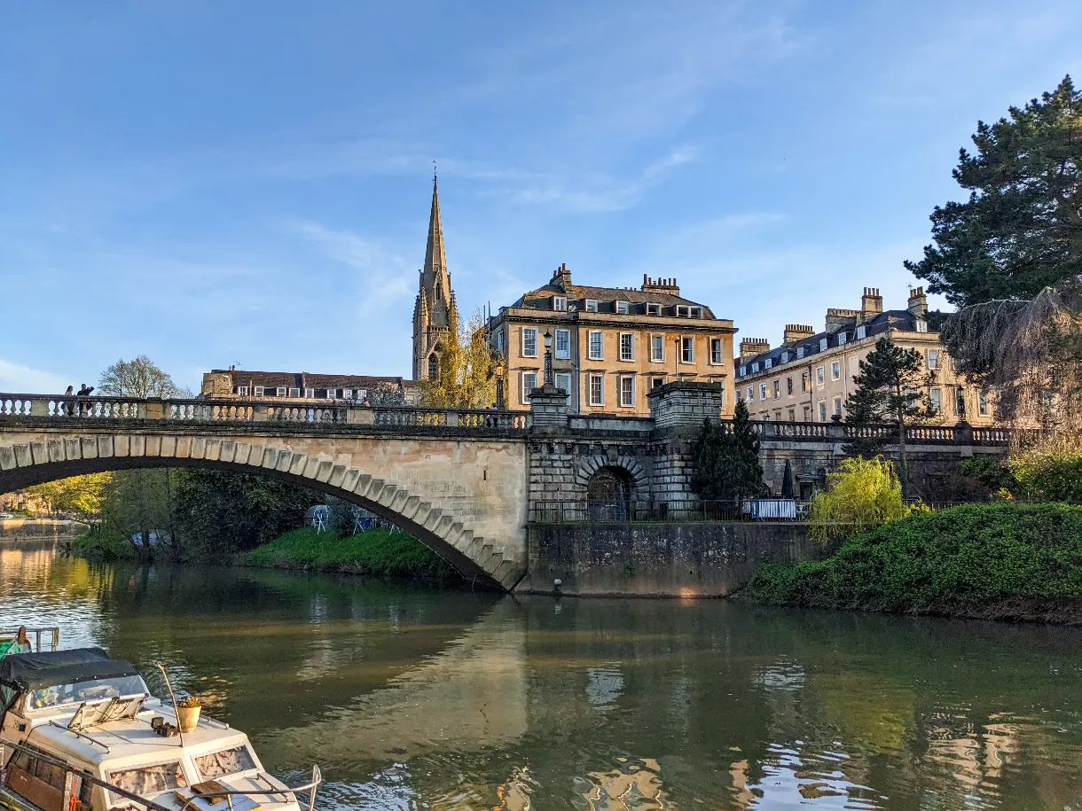 view of the city of Bath with a bridge and a church in the background