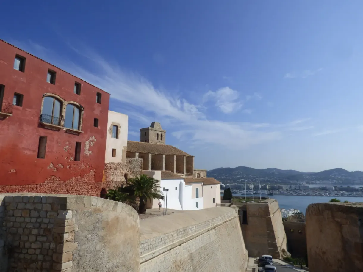 Bright red facade backing onto the ramparts above the harbour