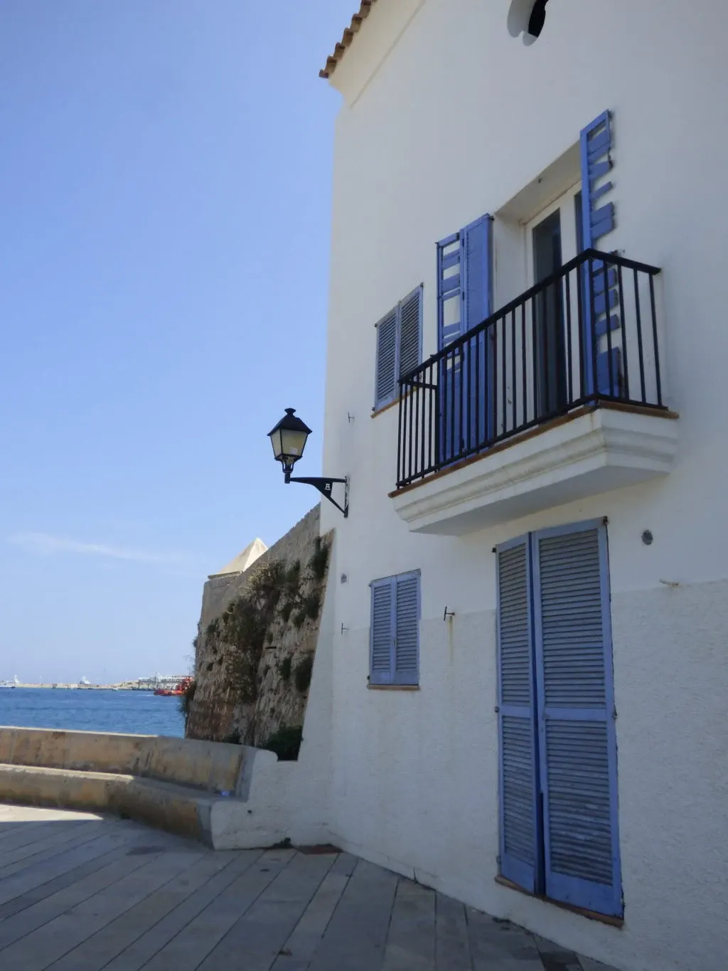 White house with blue shutters overlooking the seafront