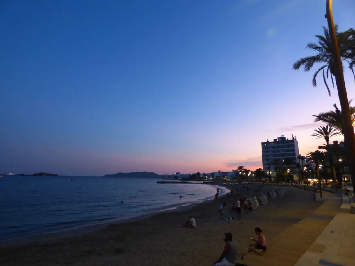 Pink and blue dusk over the busy beach