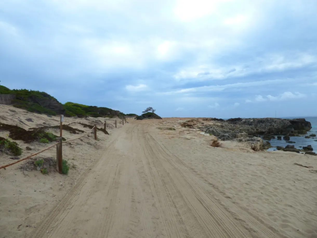 Sandy track running between dunes and rocks