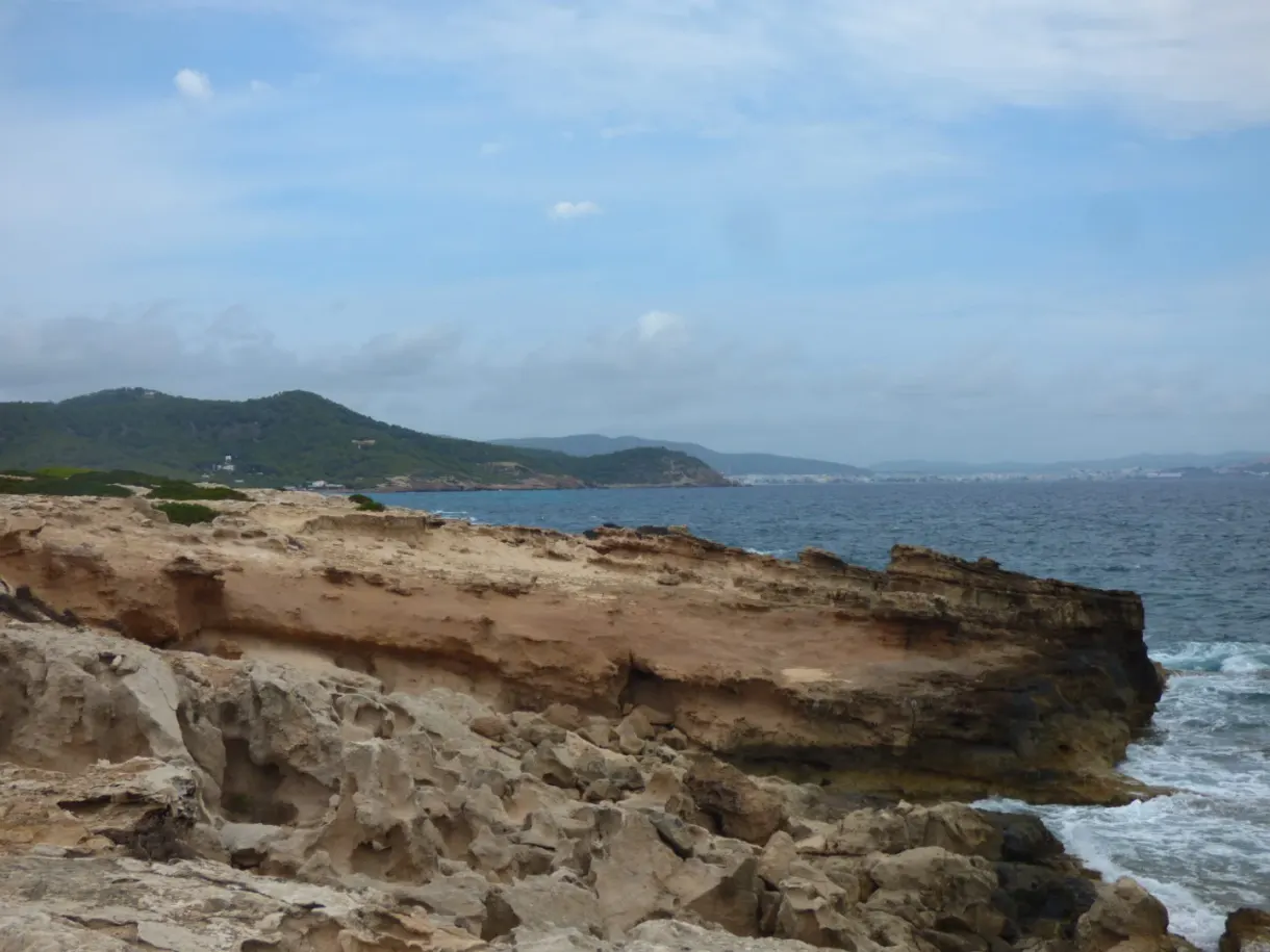 Striated cliffs battered by a rough sea