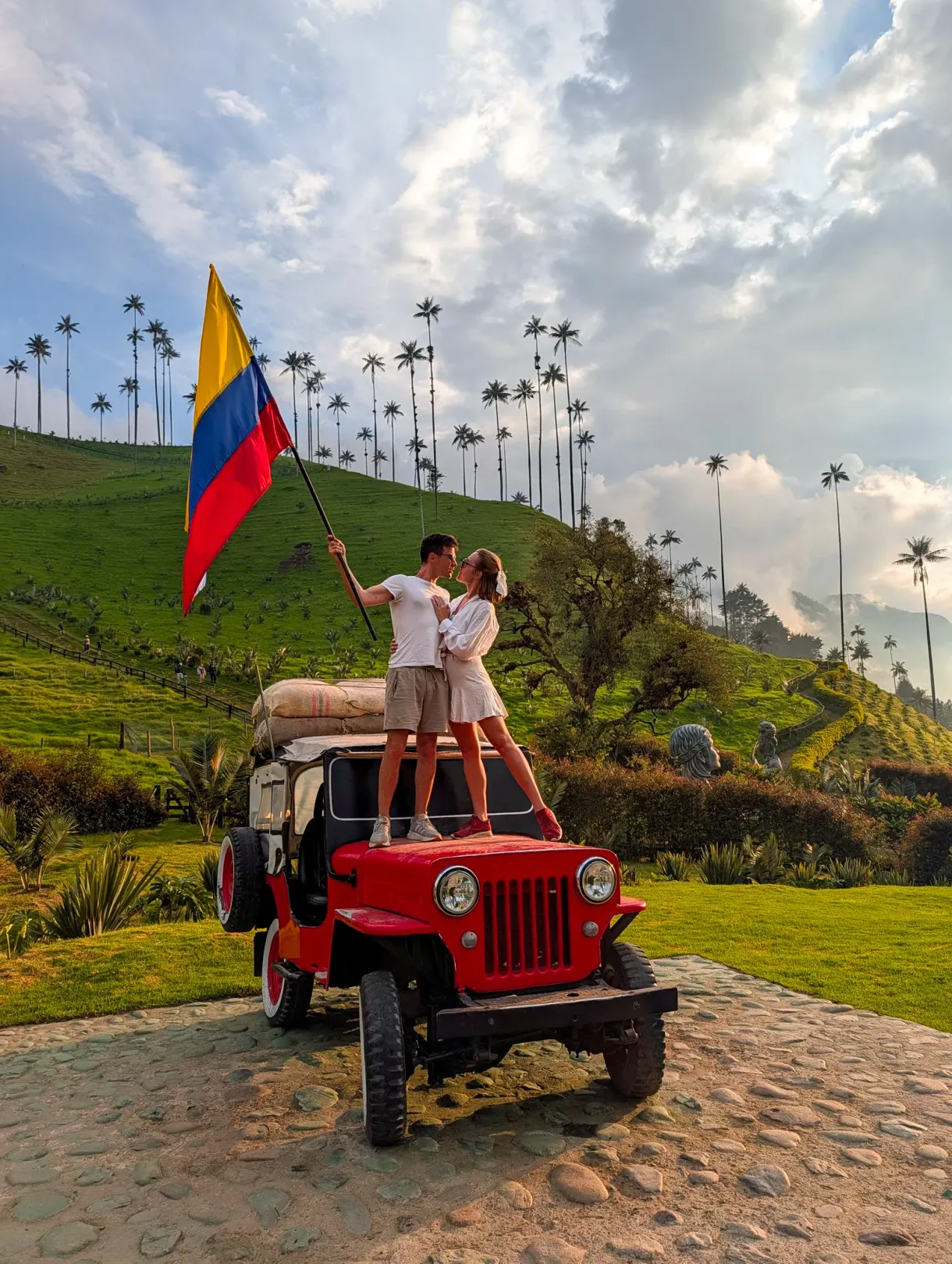 Marie and Romain on a Willys jeep with the Colombian flag in the Cocora Valley