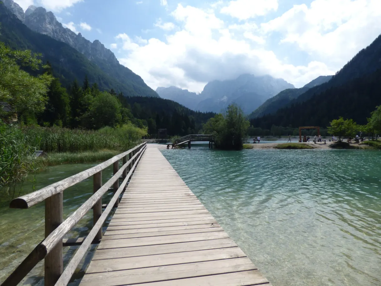 Wooden pontoon reaching out over the clear water of Lake Jasna