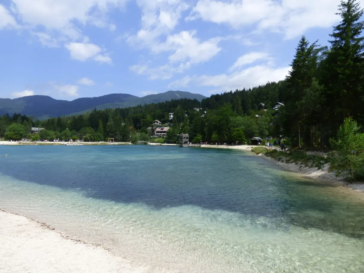 Turquoise lake ringed with forests and chalets