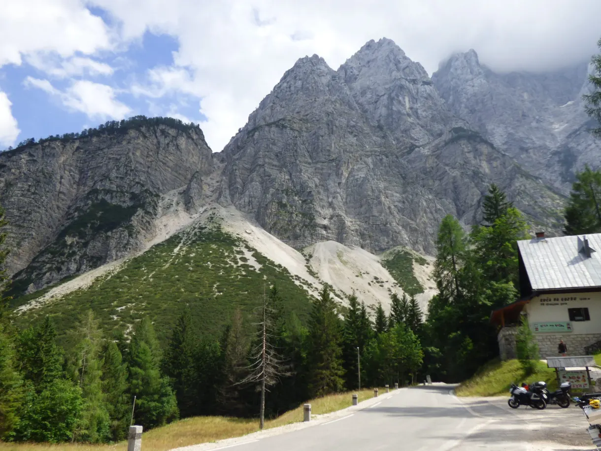 Motorbike parked at the roadside facing the jagged peaks