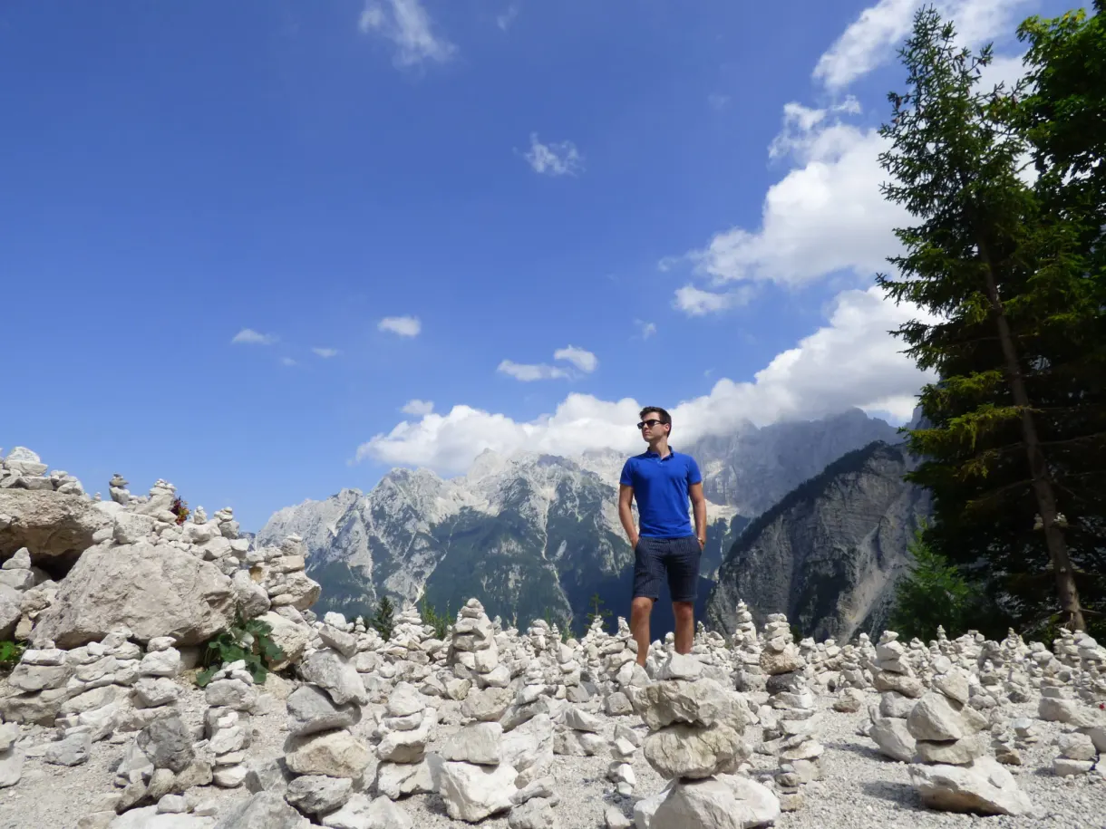 Man standing in the middle of the white stone cairns