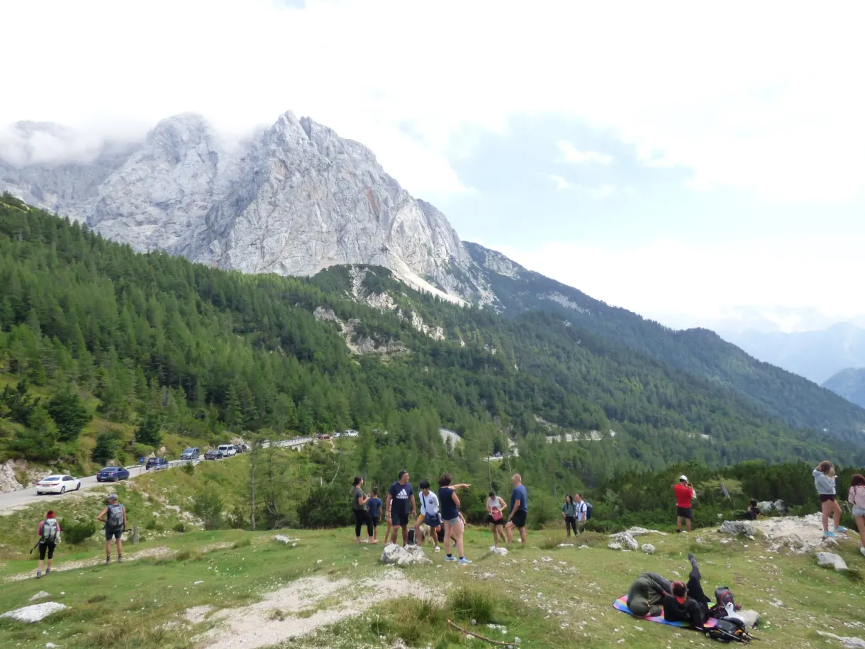 Hikers gathered in front of the cloud-veiled summits